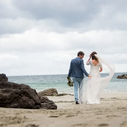 Groom and bride walk on beach, Bay View House, Clare Island